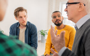 A group of men talking to one another.